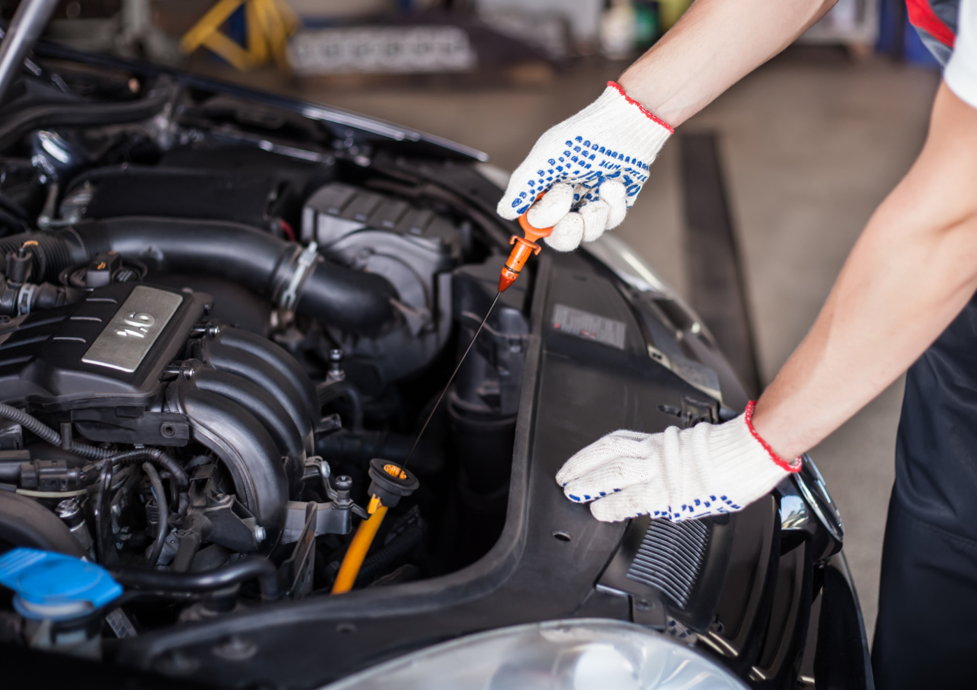 Mechanic checking engine oil - MOT, Servicing & Tyres Totton